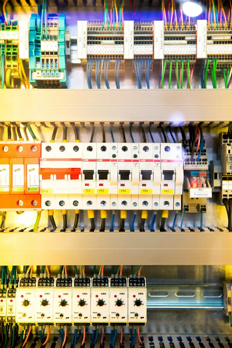 Wired control panel with rows of circuit breakers and terminals